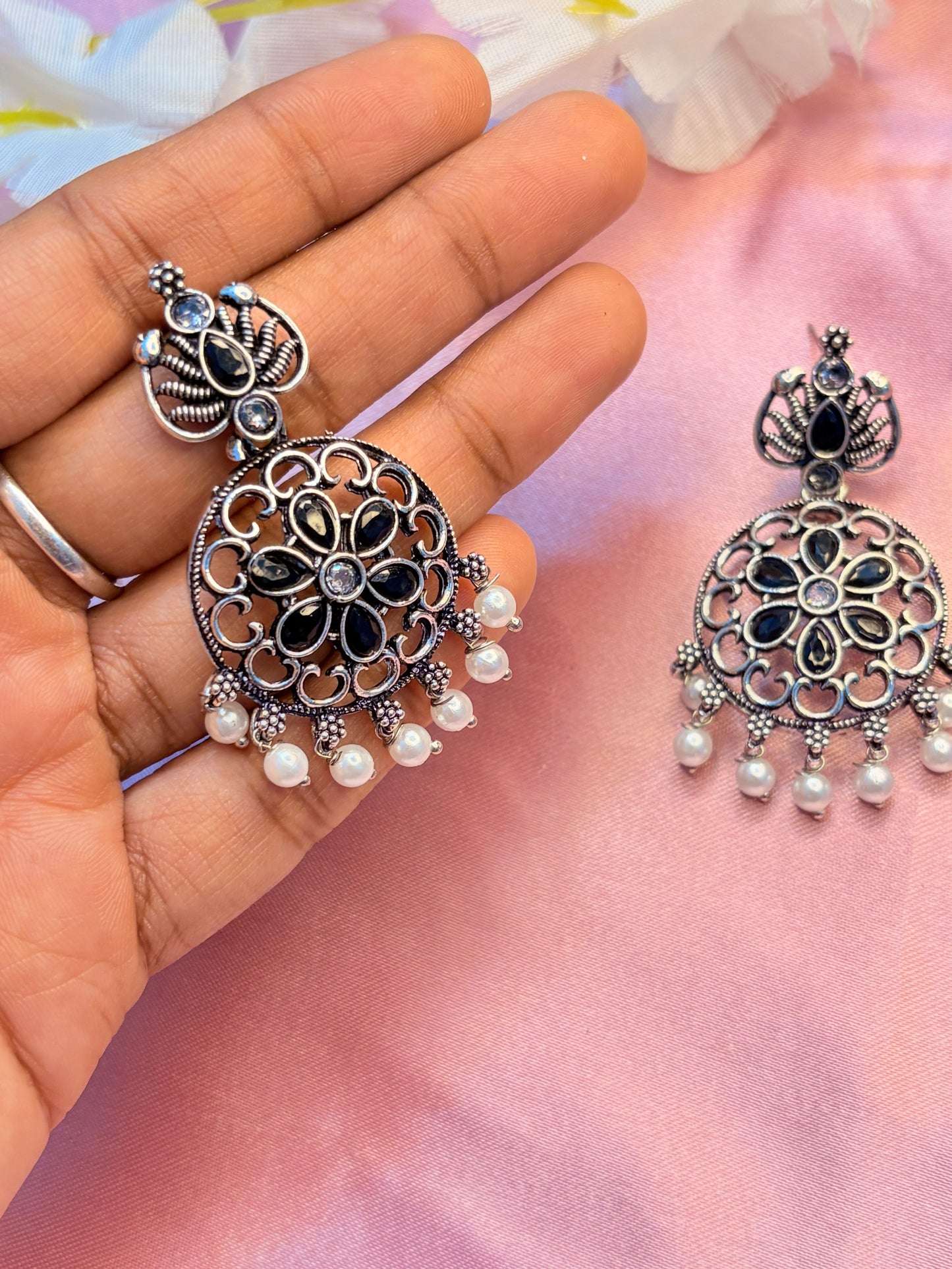 Black ornate earrings with pearl